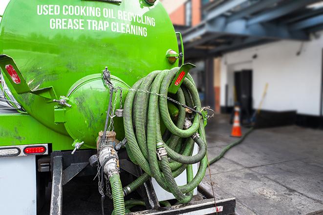 a grease trap pumping truck at a restaurant in Joliet